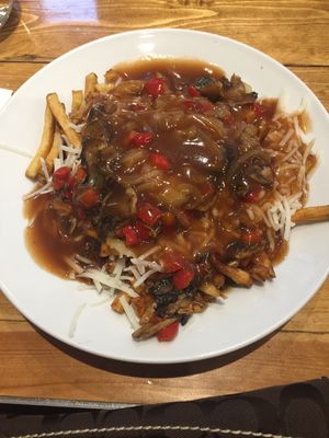 Poutine with vegan cheese, onion, mushroom, roasted red peppers and poutine gravy (2 vegan gravy choices) at Poutineville in Quebec