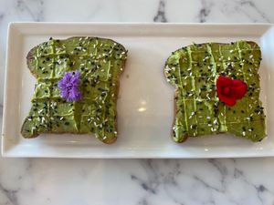The red edible flower is the best, lemony. Avocado toast.  at Pure Food and Juice in Tulsa