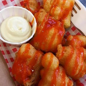 Caulifire bites. Beer-battered cauliflower, buffalo hot sauce served with a vegan blue cheese dip. You can get them as a side or on their own. Really good at Bia Kitchen Vegan Diner - Food Stall in Norwich