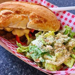 Philly Cheesesteak with a side of caesar salad, topped with herby breadcrumbs. SO BOMB
 at Bia Kitchen Vegan Diner - Food Stall in Norwich