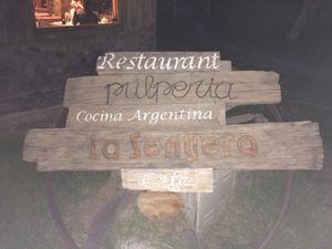 sign in the grass in front at La Senyera in El Chalten