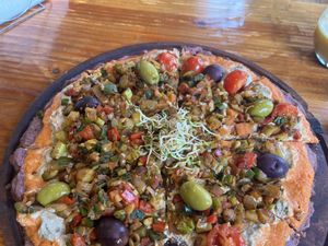 Pizza with buckwheat dough and veggies  at Curcuma in El Chalten