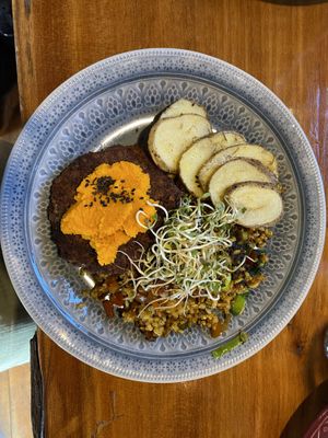 Aduki bean burger patties with carrot cream, rice, sautéed veggies and baked potato  at Curcuma in El Chalten