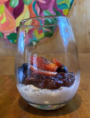 Cashew cream with berry compote and fresh blueberries and strawberries   at Curcuma in El Chalten