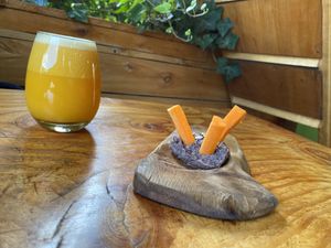 Orange, grapefruit, lemon and ginger juice along with appetiser (complimentary with meal) of carrots and bean dip. Yum!!   at Curcuma in El Chalten