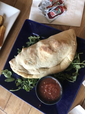 Calzone with garlicky marinara sauce  at Root in Lancaster