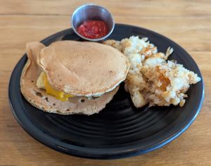 egg, cheese, and sausage between pancakes and served with hash browns at Root in Lancaster