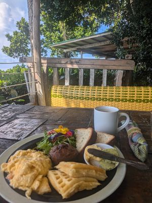 Breakfast. They changed the ham for a beautiful salad with edible flowers and pineapple at Buzzz Cafe in Panglao