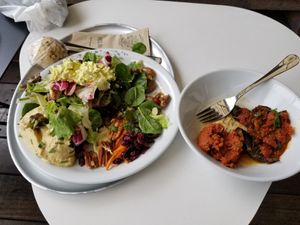Green salad, carrots, pumpkin seeds, cranberries, pecans, hummus, tofu "egg" salad... eggplant curry, vegan tartare at Hiltl - Dachterrasse in Zurich