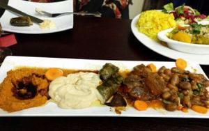 Mezze Platter featuring muhammara, hummus, dolmas, mousaka, and fava beans at Cafe Turko in Seattle
