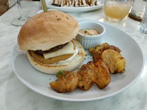 Sausage egg cheese bun with delicious smashed potatoes! at Green Bar in Makati