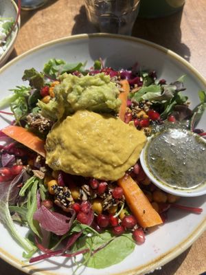 Eastern bowl: black rice, salad, carrots, curry chickpeas, mango hummus, avocado hummus, spiced seeds, cilantro topping  at By Lima in Haarlem