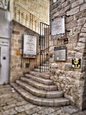 Look for this sign and go up these stairs. at The Quarter Cafe in Jerusalem