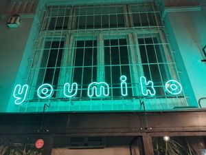 This is the sign outside at Youmiko Vegan Sushi - Hoża in Warsaw