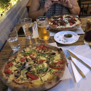 The front pizza is the vegan veggie which was delicious and really cheesy. The back pizza was a dairy and meat pizza which my omni friend said was great. at Mystic All Day Cafe in Athens