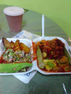 Local Fresh ground provisions, savory stew with peas, veg, herbs and fresh coconut milk, super green salad and  steamed veg, and a glass of fresh raw ginger beer. Healthy and delicious! at Roots Reggae Vegetarian Cafe in Bridgetown