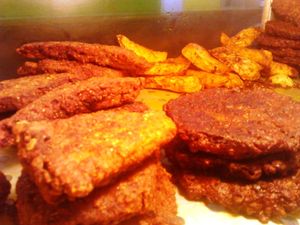 Vegan snacks - Lentil Fries/patties to the right, Seasoned potato wedges behind and Gluten slices to the left. Everything seasoned with natural herbs and spices and freshly made from scratch. at Roots Reggae Vegetarian Cafe in Bridgetown
