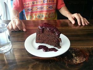 Chocolate cake with dark berry sauce 😋 at The Pitted Date in Playa Del Carmen