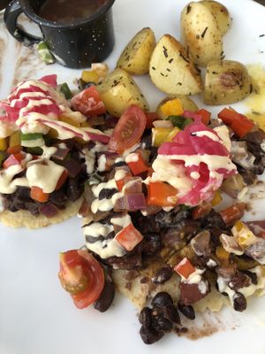 Huevos Rancheros w/black beans & Potatoes. Cut open so you can see the layers at The Pitted Date in Playa Del Carmen