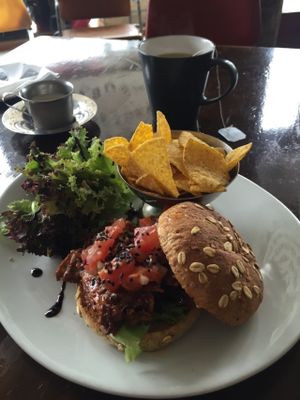 Delicious mock meat sandwich with tortilla chips! Really quick service and all vegan. Very cool cafe with old vinyl playing and nice shabby chic industrial interior. Yum!  at Kaffi Vinyl in Reykjavik