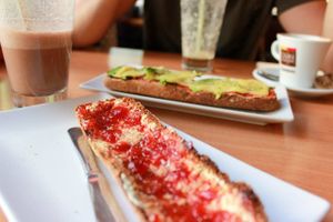 toast with margarine and strawberry jam, toast with avocado and vegan cheese and chocolate smoothie at Hicuri in Granada
