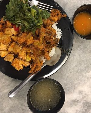 Economy rice: white rice with stewed greens and tofu, braised tofu, fried bitter gourd and winter melon and sweet corn soup. Self-serve chilli sauce in a separate bowl.  at Veggie Time in Kota Kinabalu