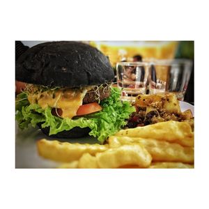 charcoal burger with fries and quinoa fruit salad.  at LN Fortunate Coffee - Solaris Mont Kiara in Kuala Lumpur