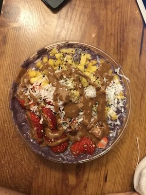 Blue almond smoothie bowl with strawberries, mangos, hemp seeds, and coconut toppings and almond butter drizzle at Dulce Vida in Hanover Park