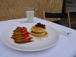 Pancakes caramelized apple and strawberries at Powoli in Wroclaw