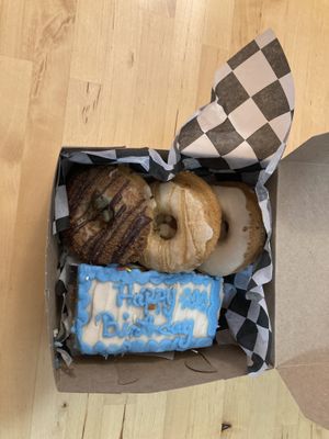 Birthday cake and three type of donuts at Erin McKenna's Bakery in New York City