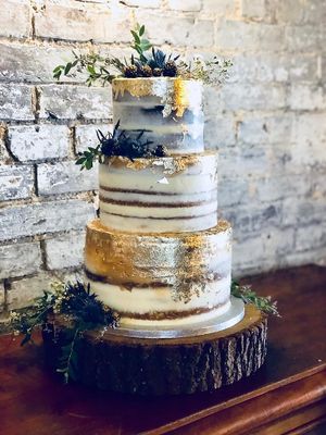 3 tiered wedding cake. Semi naked icing, thistles, blackberries and hand painted gold leaf.  at Cupcakes and Shhht in East London