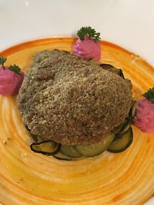Bronte pistachio paned seitan on a courgette bed  at L'Orto Gia Salsamentario in Turin