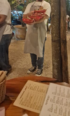 Waiter with burritos at Burrito Amor in Tulum