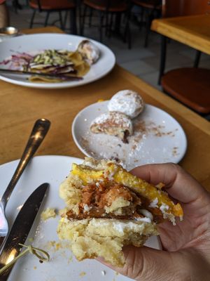 Almost forgot to snap a photo before it was gone. Breakfast sandwich in hand, beignets in background at Reverie Cafe + Bar in Minneapolis
