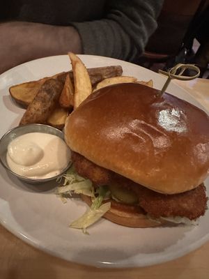 Chicken sandwich with side of potato wedges   at Reverie Cafe + Bar in Minneapolis