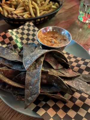 The cheese sauce for the chips was great. Fries in the background had dill spice but weren’t super flavourful despite that.   at Lucky Pig - Paradise Palms in Edinburgh