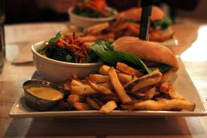 Double bacon (seitan and coconut) double cheese (chao and queso)burger with salad and fries at MeeT in Gastown in Vancouver