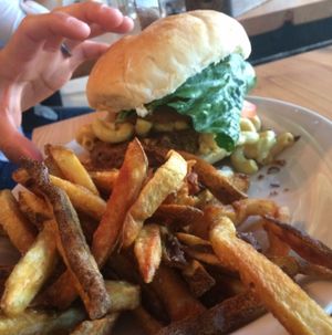 Mac and cheeze burger. hand for size comparison  at MeeT in Gastown in Vancouver
