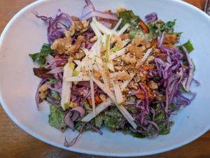 Salad with cabbage, sweet potatoes, candied walnuts, and sliced green apples at MeeT in Gastown in Vancouver