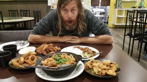 A feast of squid rings, tempura mushrooms, fried chicken, steak rice and a clay pot at Formosa Vegetarian Eating House in Kardinya