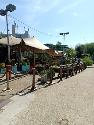 Outside under the covered area at Cafe De Ceuvel in Amsterdam