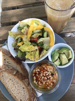 Ginger lemonade and vegan plate with side avocado. Ask for vegan dressing.  at Cafe DA in Stuttgart