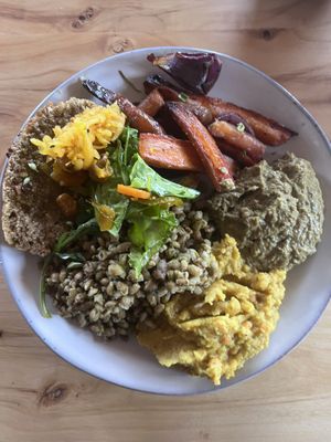 Roasted veg, bread with fermented veg, barley, yellow lentils, and a mashed green dish (?)  at Modir Jord in Egilsstadir