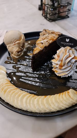 Vegan chocolate fudge cake with vegan ice cream, coconut whipped cream and soy caramel at Veganerie Concept - Benjasiri Park in Bangkok