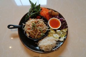 A mixed plate with papaya salad, spring roll, rice noodles, other veggies.. delicious! at Veganerie Concept - Benjasiri Park in Bangkok