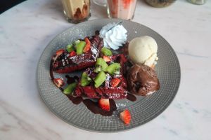 Red velvet waffles with vanilla icecream and brownie icecream. Not enough chocolate sauce, waffles are just plane tasting waffles, but the icecream is amazing! at Veganerie Concept - Benjasiri Park in Bangkok