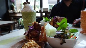 chicken and waffles with peanut sauce and a matcha shake  at Veganerie Concept - Benjasiri Park in Bangkok