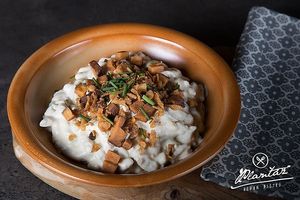 Slovak potato dumplings with vegan "cheese" sauce and cracklings at Plantaz Bistro & LimeLight BAR in Martin