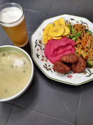 Peanut soup, juice drink, banana chips, pureed beets, grain croquettes, sauteed vegetables at Tulsi Plant Based in Envigado
