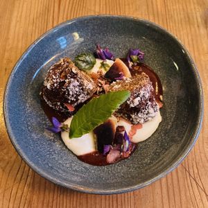 Dessert April 2023 featuring gold-covered raw carrot cake that I managed to photograph from its unspectacular side.😅  at Urten in Copenhagen